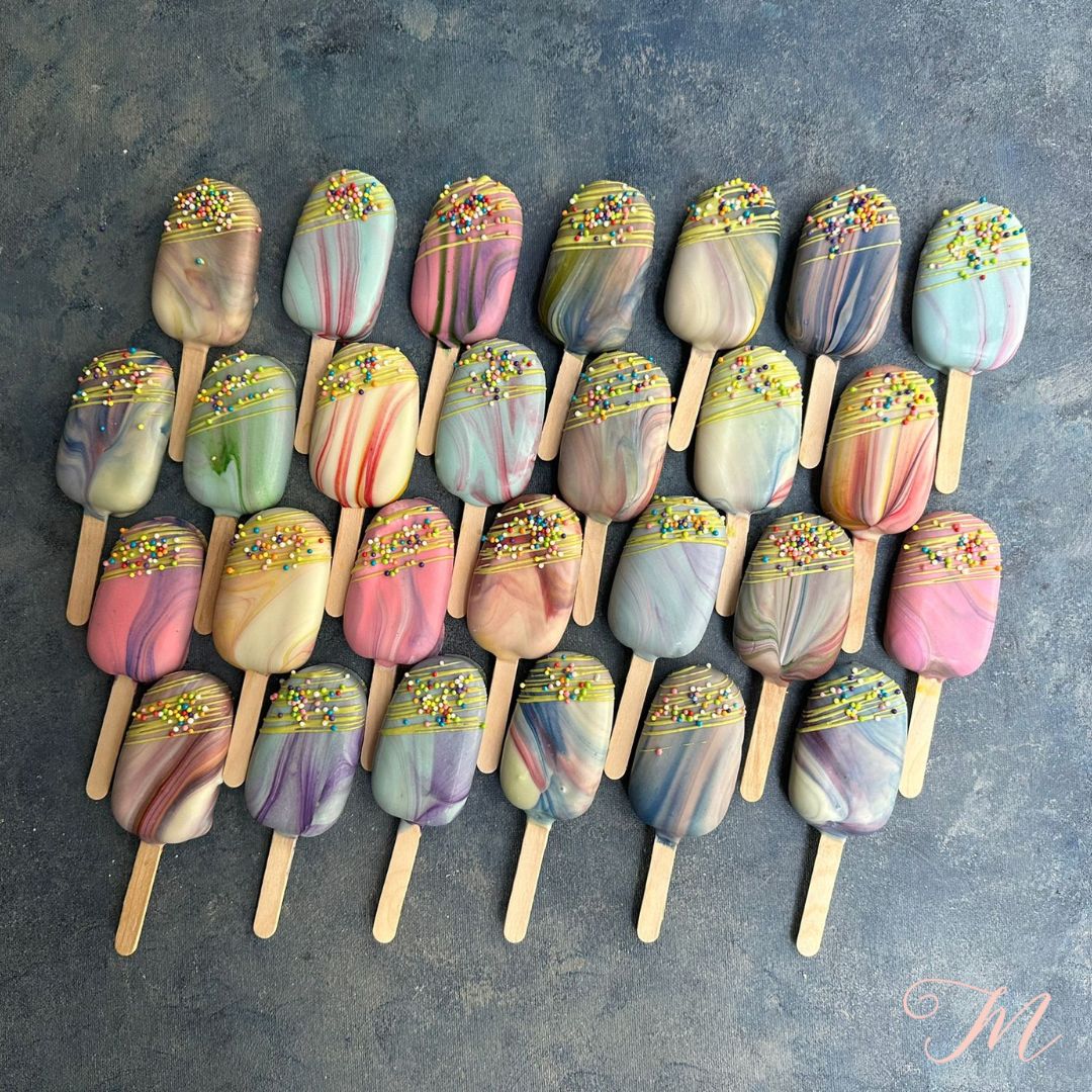 Set off marbled eggless and Gluten-free cakesicles. Muticoloured cakesicles