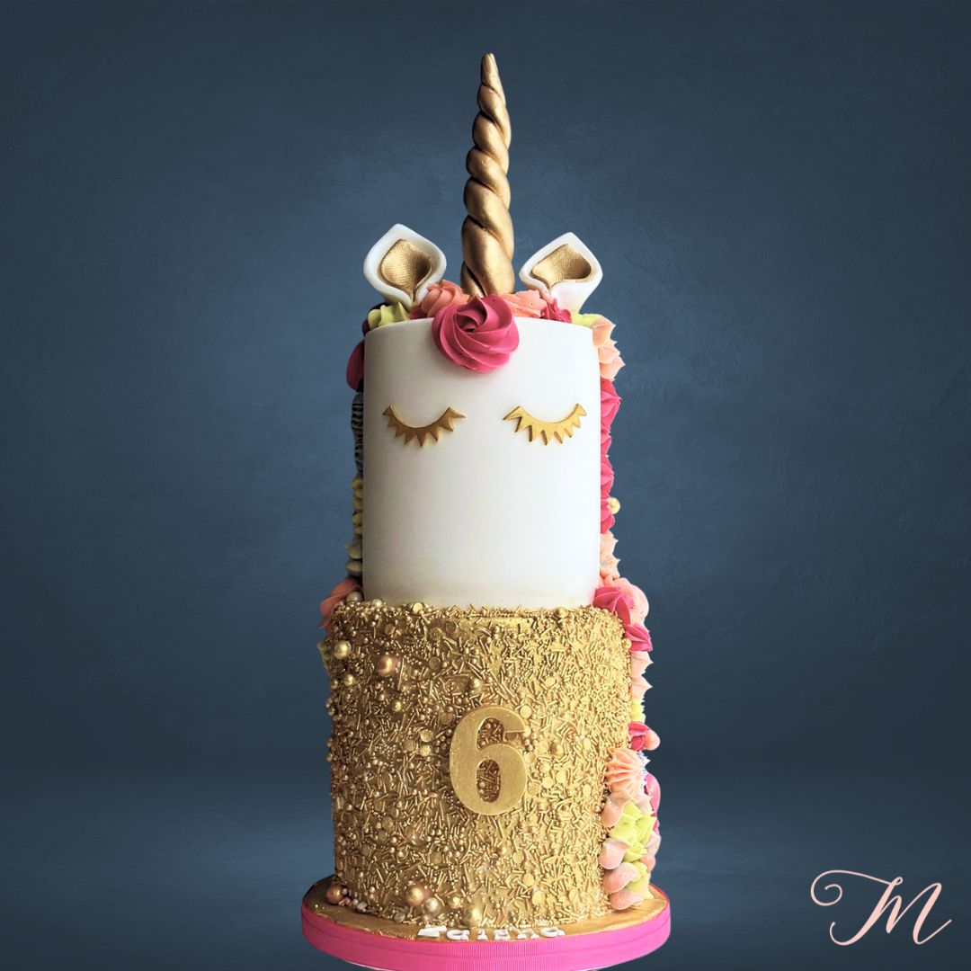Personalised unicorn birthday cake in Singapore with colourful pastel buttercream mane, golden horn, name and age plaques.