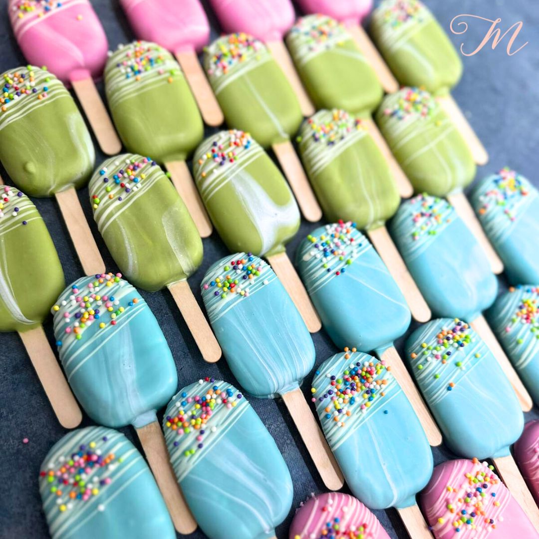 A set of eggfree cakesicles with a marbled design