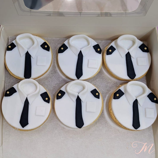 A box of handcrafted biscuits decorated to resemble a shirt and tie, primarily in white and black colors.  Personalised and customisable